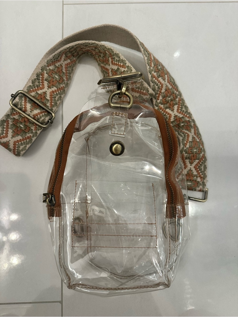 Clear Crossbody Boutique Bag with Tan Trim and Patterned Strap
